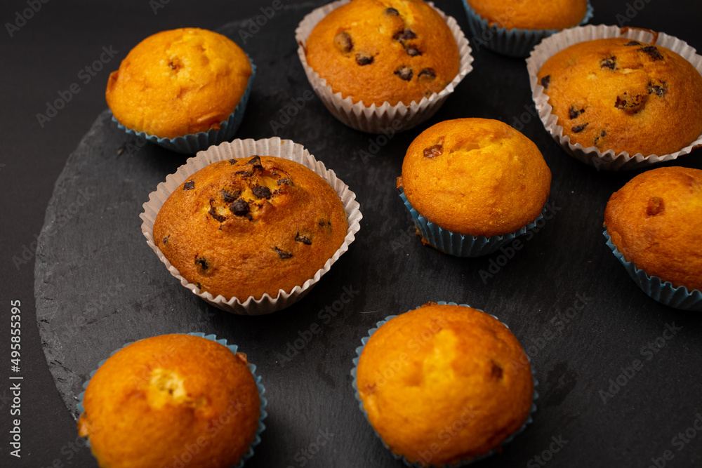 Juicy cupcakes on a black background, confectionery, bakery Juicy cupcakes on a black background, confectionery, bakery