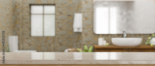 Empty space on marble bathroom countertop over blurred modern stone bathroom