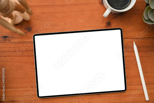 Wooden table workspace background with tablet touchpad