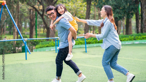 Image of young Asian family playing together at park © Timeimage