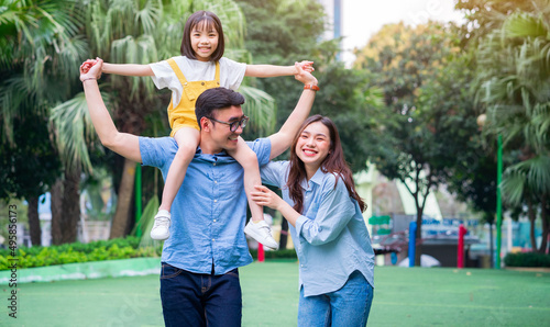 Tableau sur toile Image of young Asian family playing together at park