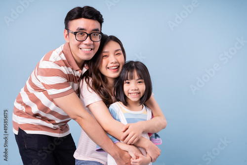 Portrait of young Asian family on background