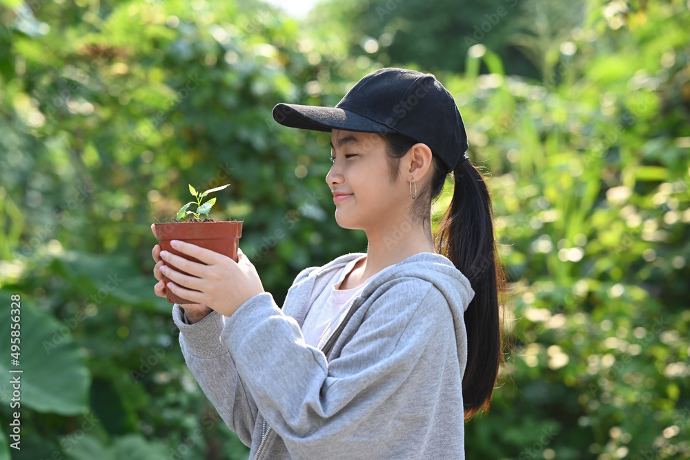 Smiling asian girl hand holding small tree for planting. Saving the world, earth day concept. Smiling asian girl hand holding small tree for planting. Saving the world, earth day concept.