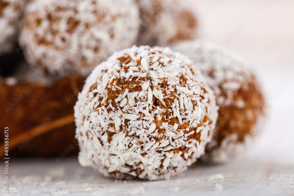 Homemade dietary candies from dates and an apricot in coconut topping. Selective focus. Copy space Homemade dietary candies from dates and an apricot in coconut topping. Selective focus. Copy space