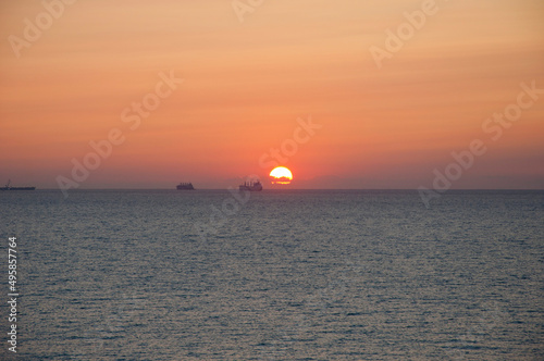 sunset sky and sea with ship on horizon  summer vacation