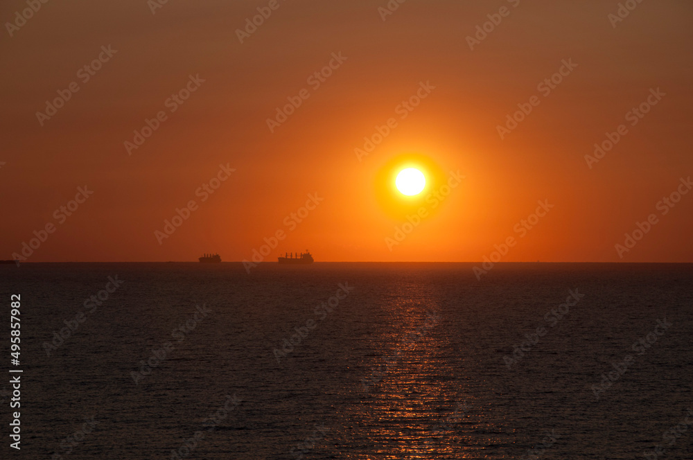 sundown sky and sea with ship on horizon, bora bora sundown sky and sea with ship on horizon, bora bora
