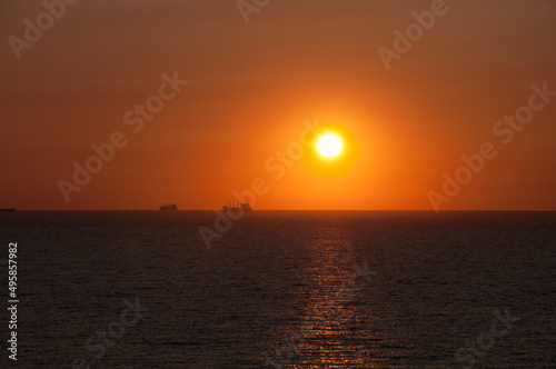 sundown sky and sea with ship on horizon, bora bora © altana_studio