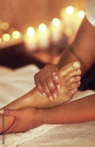 Ease the tightness of a long day. Cropped shot of a woman enjoying a foot massage at a spa.