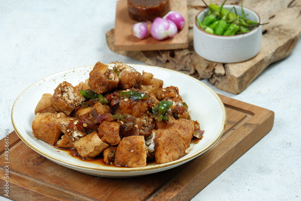 tahu gejrot , is a typical food from Cirebon, Indonesia.Traditional street food dish of fried bean curd with crushed shallot and green chili in sweet soy sauce