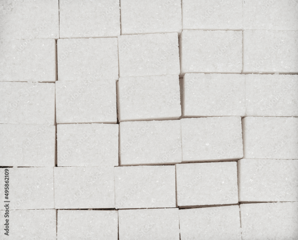 Naklejka premium Natural white sugar cubes texture background