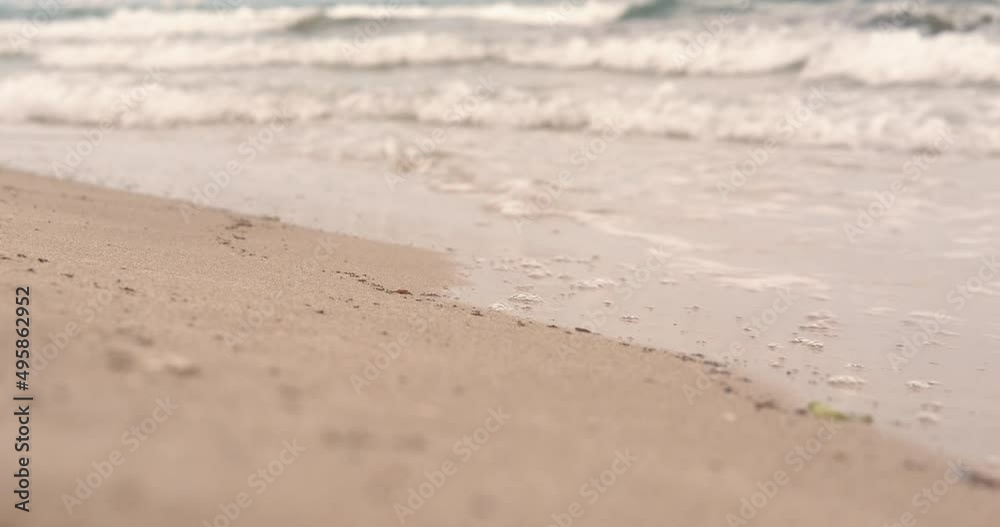 Legs along the sea waves. A teen legs makes a promenade by the sea water in the day light. Legs along the sea waves. A teen legs makes a promenade by the sea water in the day light.