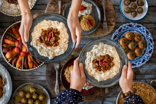 Canvas Print Many kinds of food at the hands of family members, iftar concept