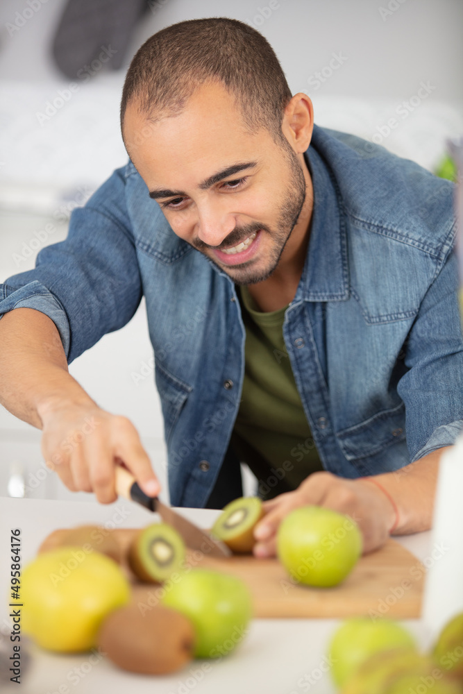 young man preparing fresh fruits young man preparing fresh fruits