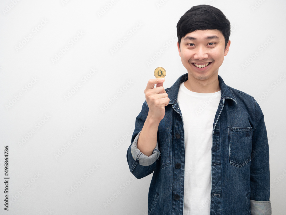 Asian man holding golden bitcoin happy smile portrait copy space