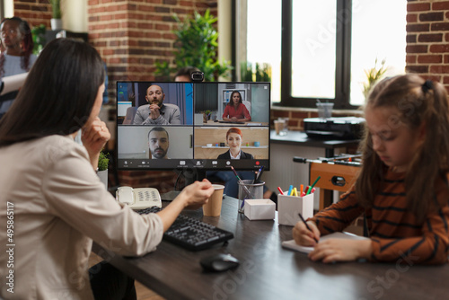 Business woman on virtual conference videocall communicating marketing strategy to company partners. Financial agency employees brainstorming client oriented project ideas while in digital meeting.