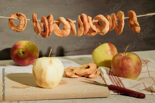 Slices of apples are dried on a rope