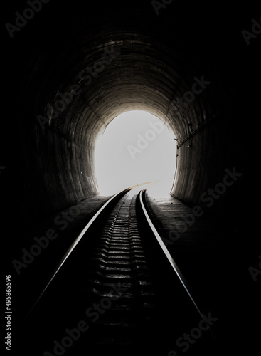 Inside the railroad tunnel and railways with natural light at the end. Light at the end of the tunnel, Lights and shadows, Concept of achieving your goals, Copy space, No focus, specifically.
