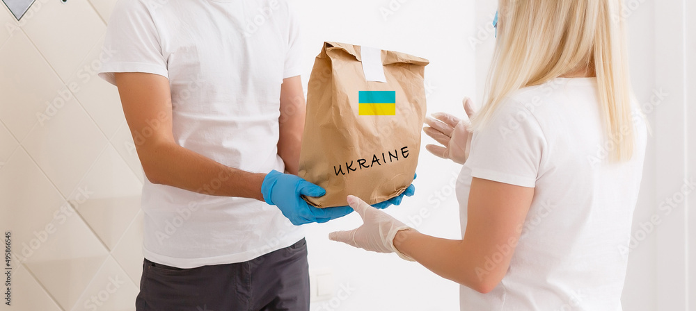 a man holds a box with humanitarian aid to ukraine a man holds a box with humanitarian aid to ukraine