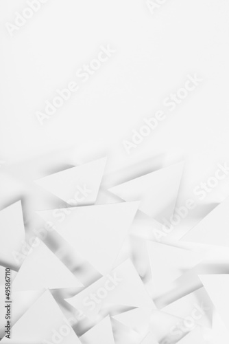 White paper triangles as abstract geometric texture in bright light with soft light shadows, top view, vertical. Simple tender purity dynamic mosaic background in minimal style.
