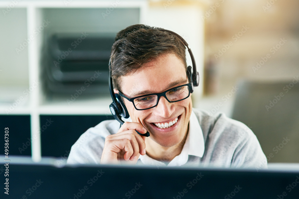 He handles every call with utmost professionalism. Shot of a young call center agent working in an office. He handles every call with utmost professionalism. Shot of a young call center agent working in an office.