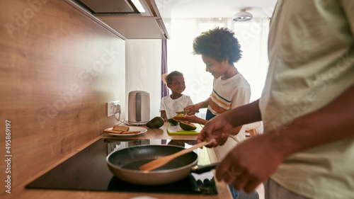 Family of father, son and daughter cook breakfast © Svitlana