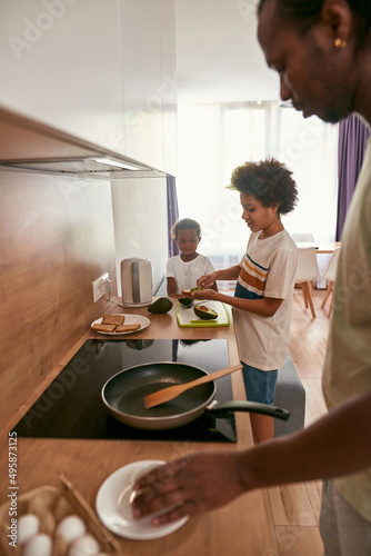 African family cooking breakfast at home kitchen