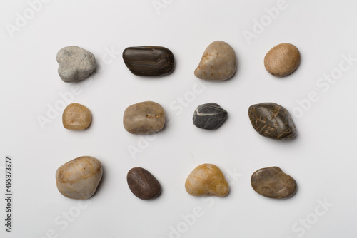 Set of sea stones on wooden background, top view