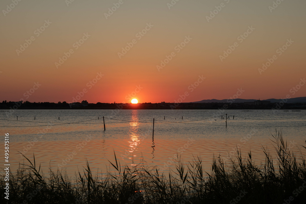 sunset over a lake , golden hour sunset over a lake , golden hour