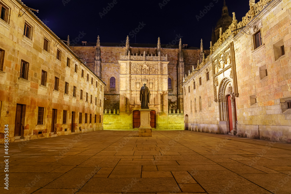 Night view of the square of medieval buildings of the University of Salamanca.