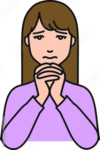 お願いごとをする若い女性