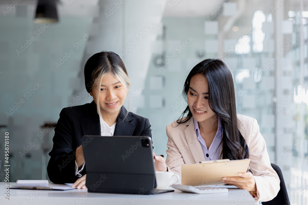 Atmosphere in the office of a startup company, two female employees are discussing, brainstorming ideas to working on summaries and marketing plans to increase sales and prepare reports to managers. Atmosphere in the office of a startup company, two female employees are discussing, brainstorming ideas to working on summaries and marketing plans to increase sales and prepare reports to managers.