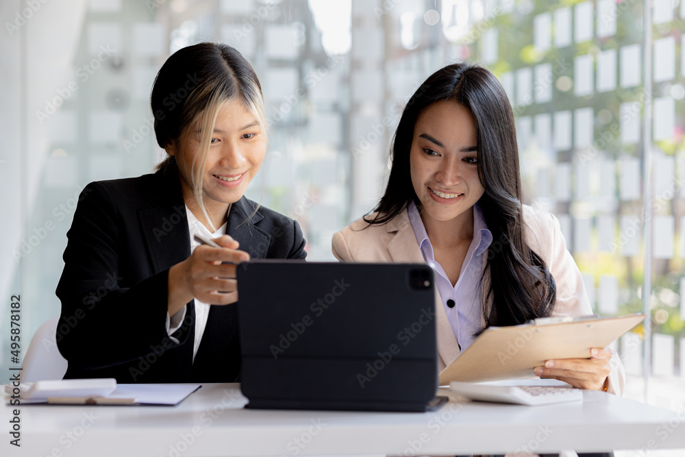 Atmosphere in the office of a startup company, two female employees are discussing, brainstorming ideas to working on summaries and marketing plans to increase sales and prepare reports to managers. Atmosphere in the office of a startup company, two female employees are discussing, brainstorming ideas to working on summaries and marketing plans to increase sales and prepare reports to managers.