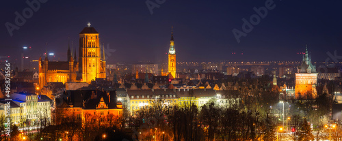 Cityscape of Gdansk with St. Mary Basilica and City Hall at night, Poland.