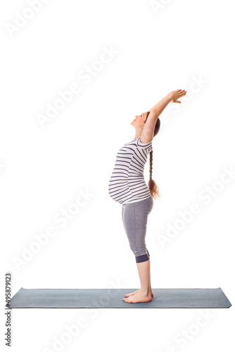 Pregnancy yoga exercise - pregnant woman doing yoga asana Tadasana Mountain pose isolated on white background photo