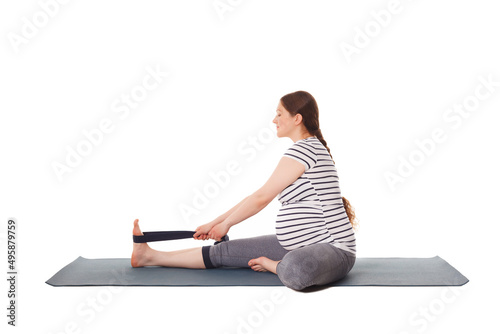 Pregnancy yoga exercise - pregnant woman doing yoga asana Janu Sirsasana A Head-to-Knee Forward Bend isolated on white background photo