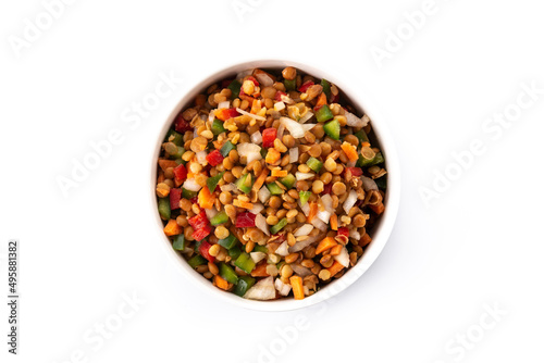 Lentil salad with peppers,onion and carrot in a bowl isolated on white background