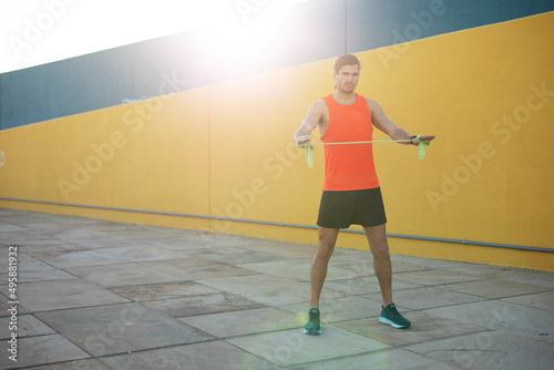 Young muscle man training outside. Fit handsome man doing exercise. Healthy lifestyle..