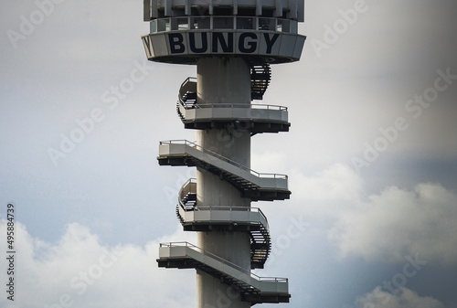 Grey bungy jump tower structure with clear sky background, extreme and adveture sports