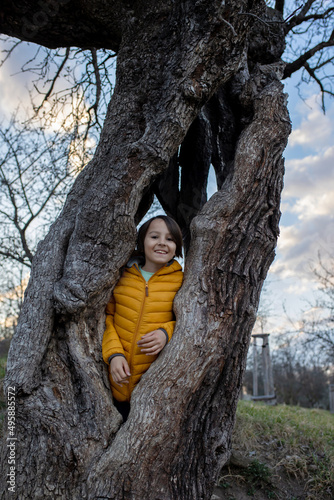 Photography Happy child, preteen boy, visiting spring park in Prague, walking at sunset