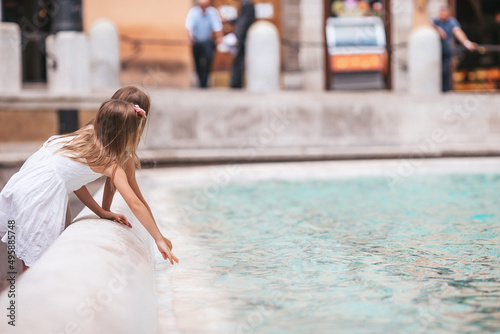 Little beautiful girls near fountain Fontana di Trevi