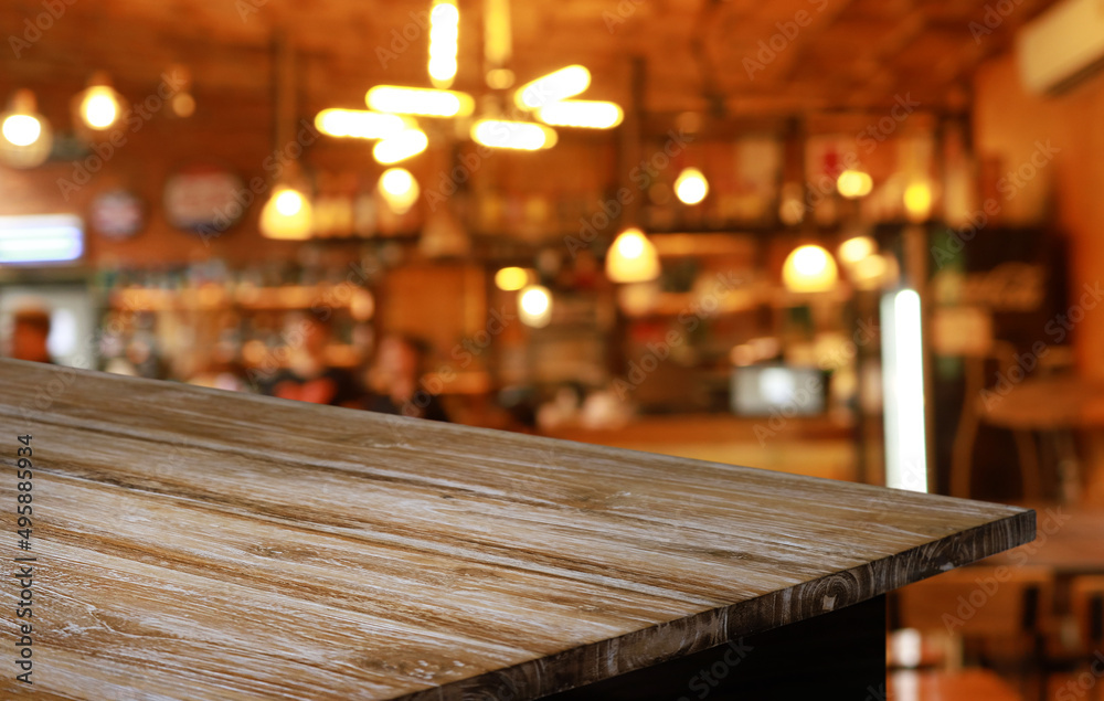 Empty wooden table in front of abstract blurred background of coffee shop . can be used for display or montage your products.Mock up for display of product