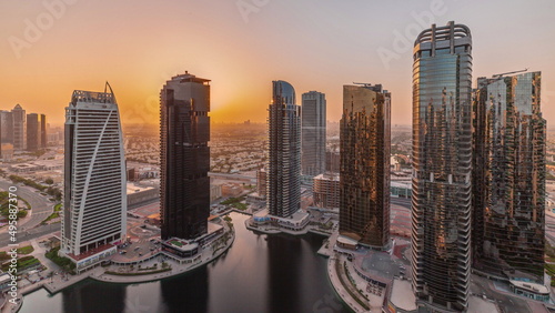 Canvas Print Sunrise over tall residential buildings at JLT aerial timelapse, part of the Dubai multi commodities centre mixed-use district