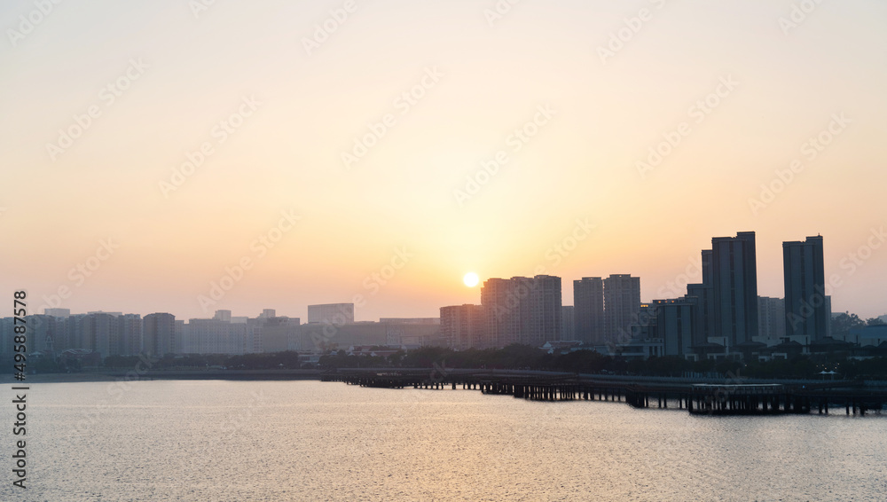 City by the sea at sunset