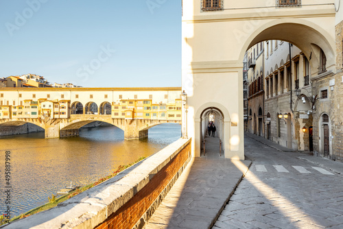 Morning view on famous Old bridge called Ponte Vecchio and arcade on Arno river in Florence, Italy. Concept of traveling Italy and visiting italian landmarks