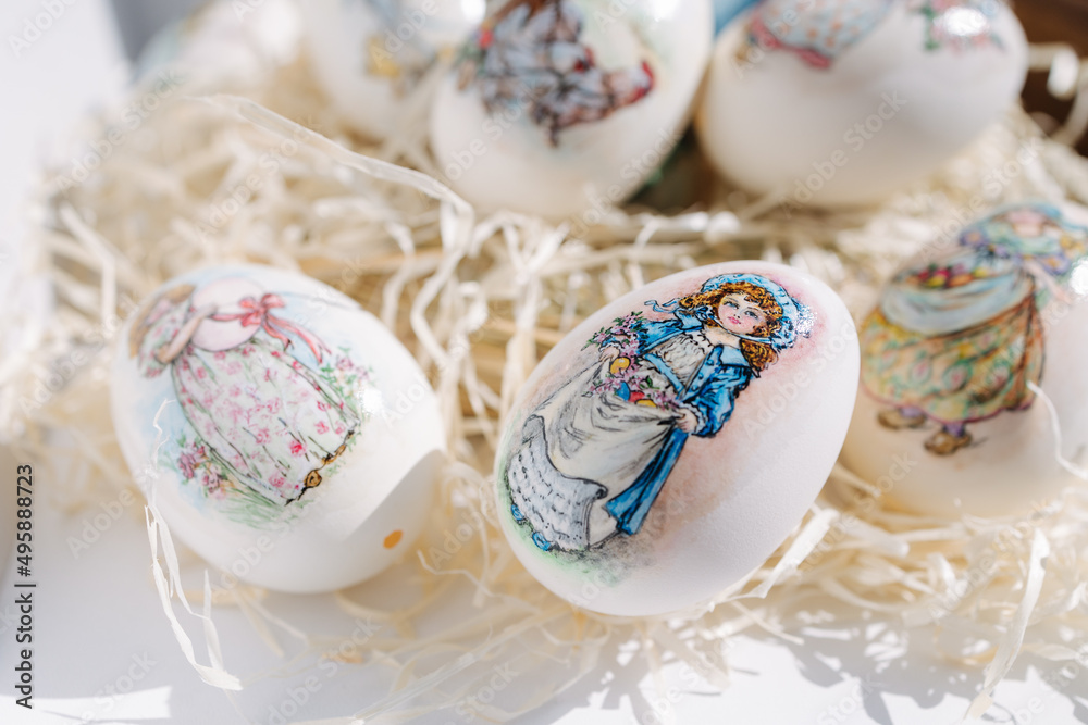 Close-up of different drawings on goose eggs for Easter festival. Eggs on hay. Hand made print. Spring hollidays. Easter concept Close-up of different drawings on goose eggs for Easter festival. Eggs on hay. Hand made print. Spring hollidays. Easter concept