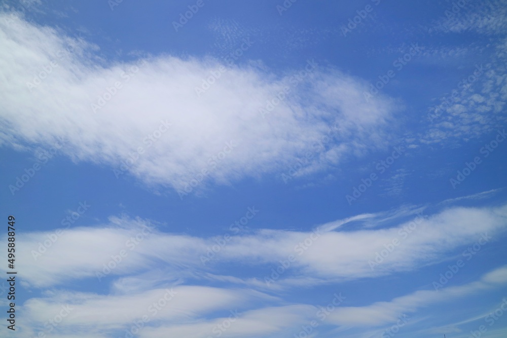 Clear blue sky with white clouds and sun in summer time. Nature background concept.