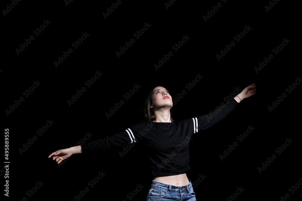 woman opening her arms happy on black background