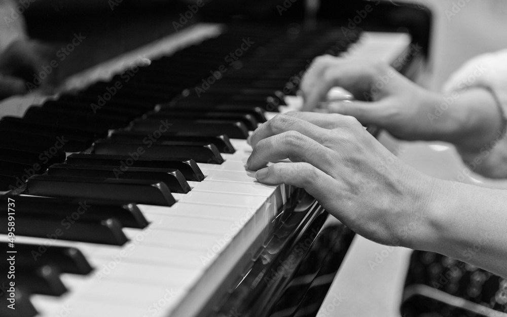 Obraz premium Close up of woman hands playing piano