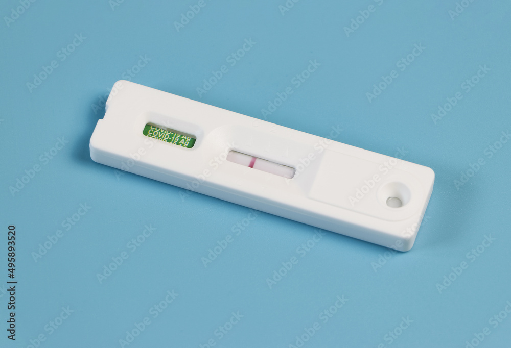 Covid-19 negative test result antigen test kit (ATK) on blue background with copy space. Covid-19 negative test result antigen test kit (ATK) on blue background with copy space.