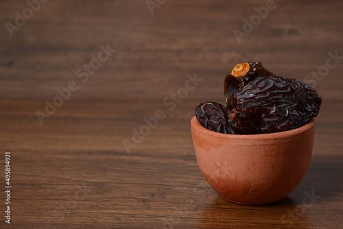 Fresh almonds in the wooden bowl, Organic almonds, almonds border white background, Almond nuts on a dark wooden background. Healthy snacks. Top view. Free space for text. photo